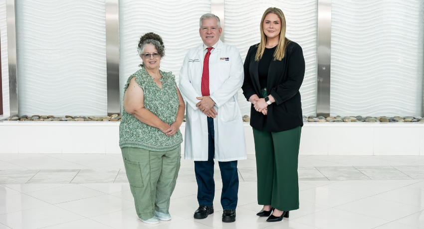 Three people pose in a hospital lobby at UTMB Health League City Campus following the campus’s accreditation as a Total Joint Replacement Center of Excellence.