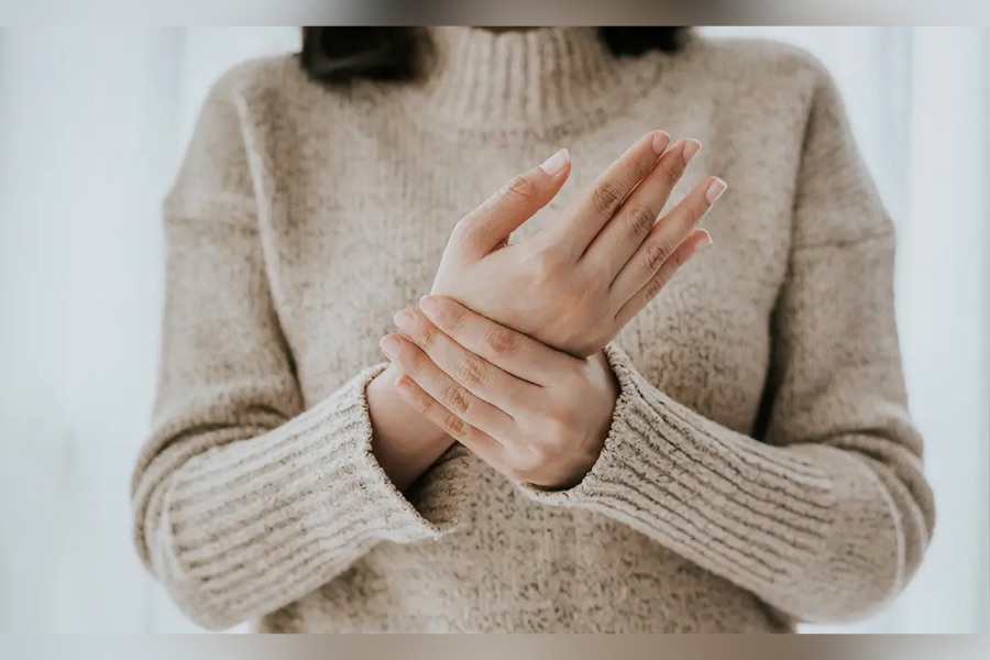 Woman holding hand and wrist