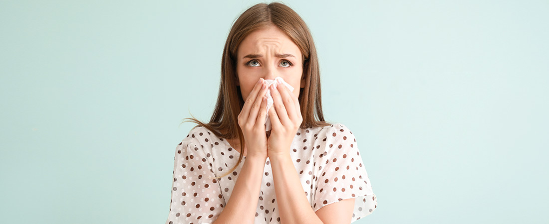 woman blowing nose