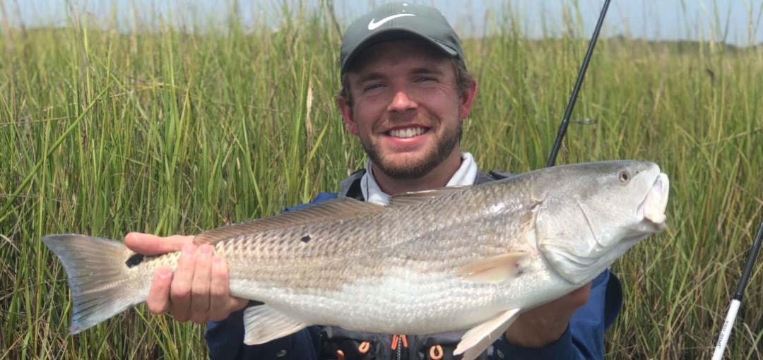 Blake Northrop holding a redfish