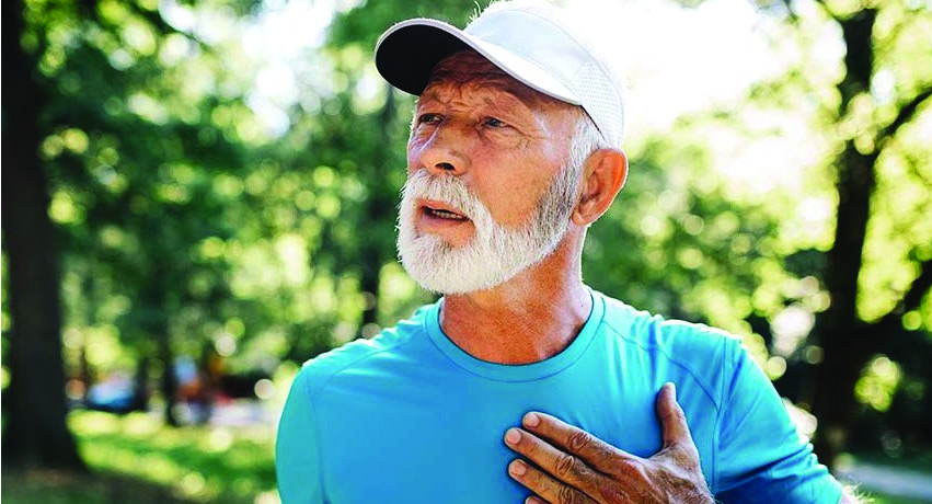 Older man holding chest