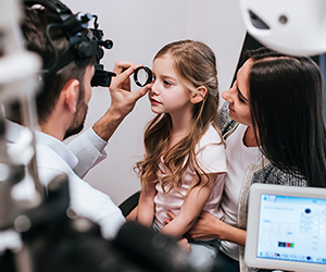 Girl getting eyes examined