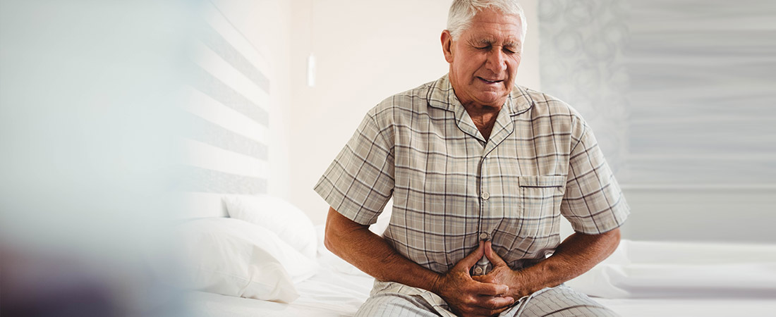 older man holding stomach