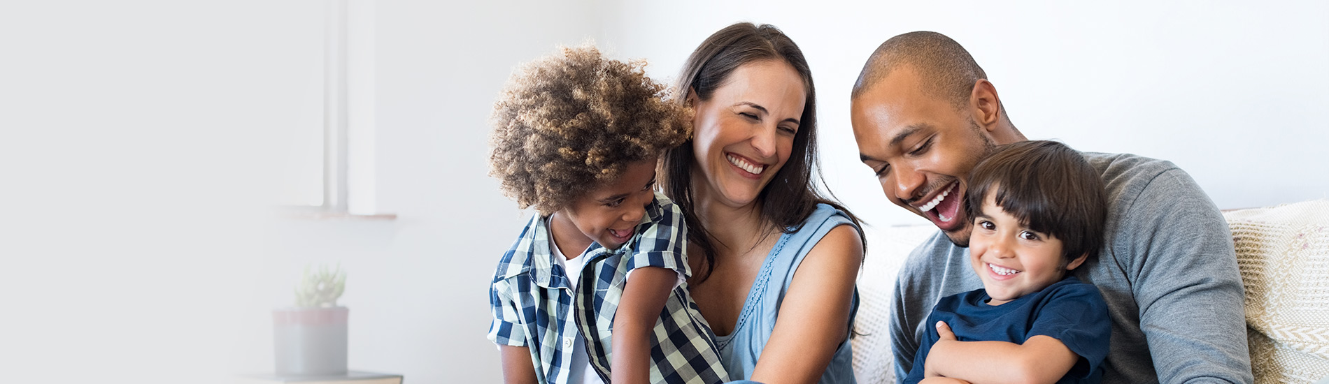 A family of four laughing together