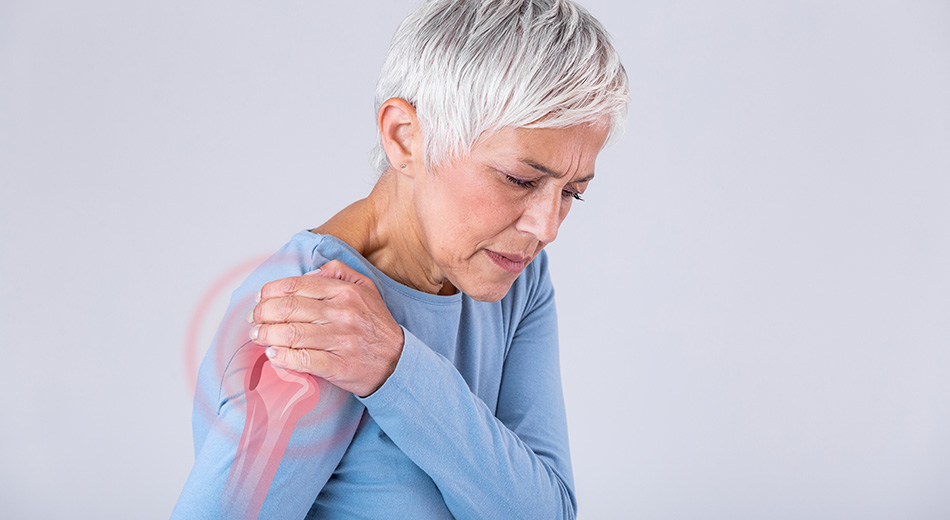women holding shoulder in pain