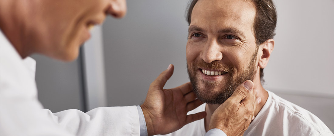 doctor checking man's neck